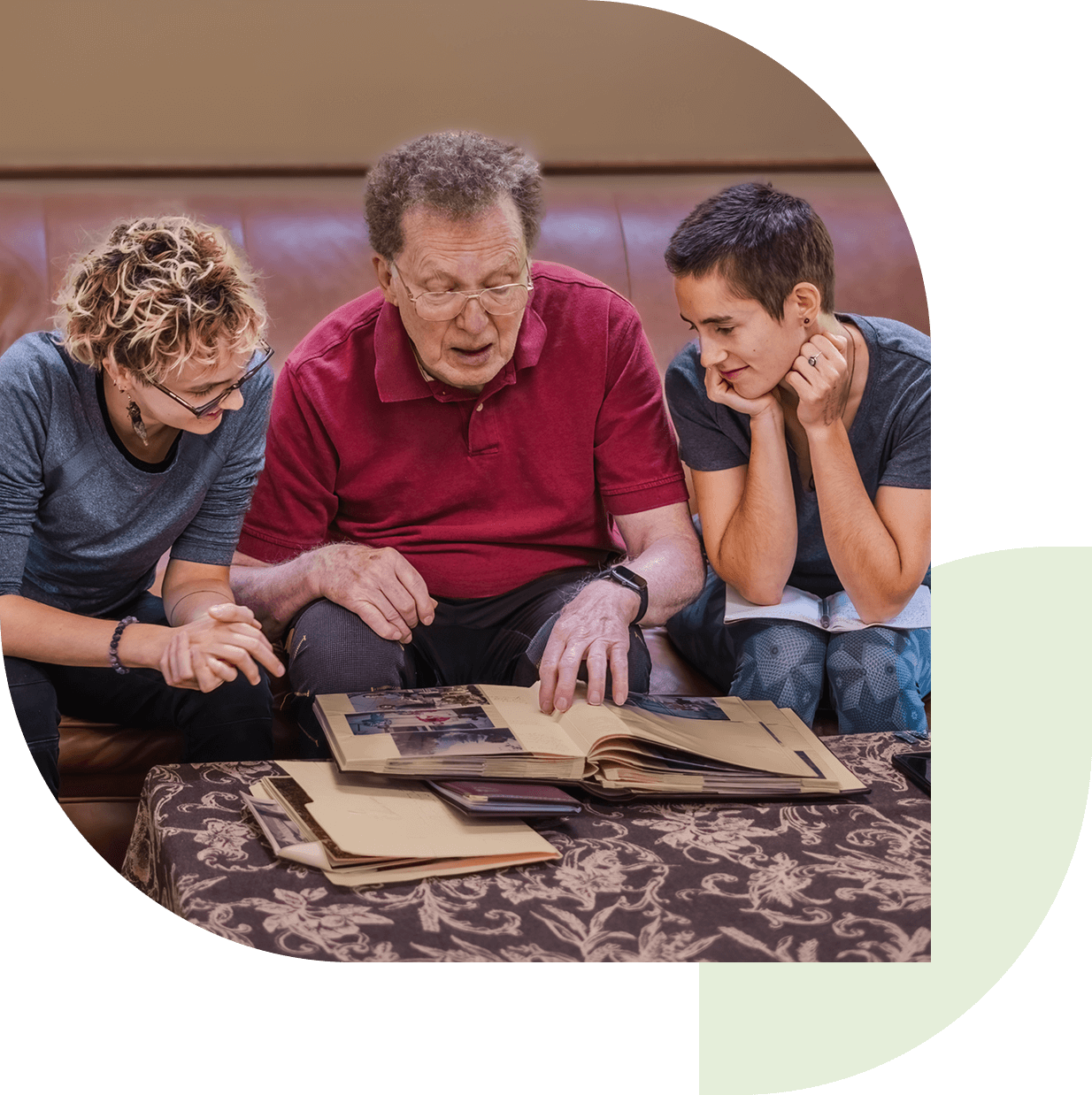 Three people looking at a photo album.