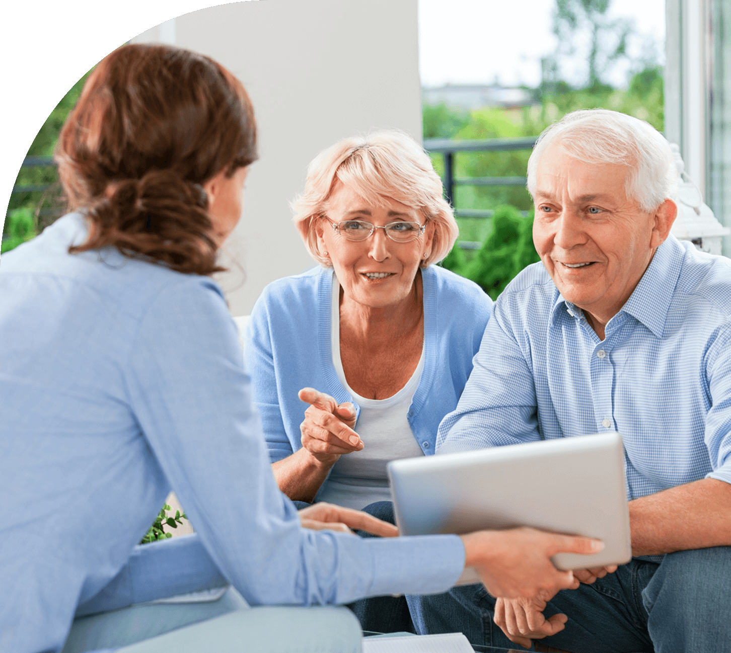 Elderly couple consulting with a professional advisor.